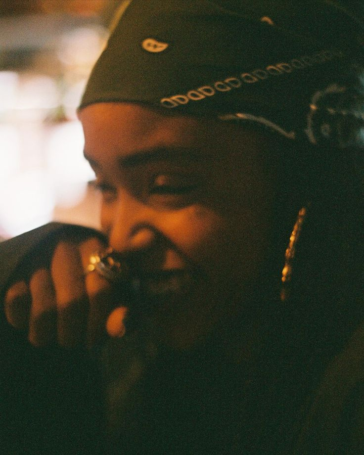 Young woman smiling warmly in a bandana
