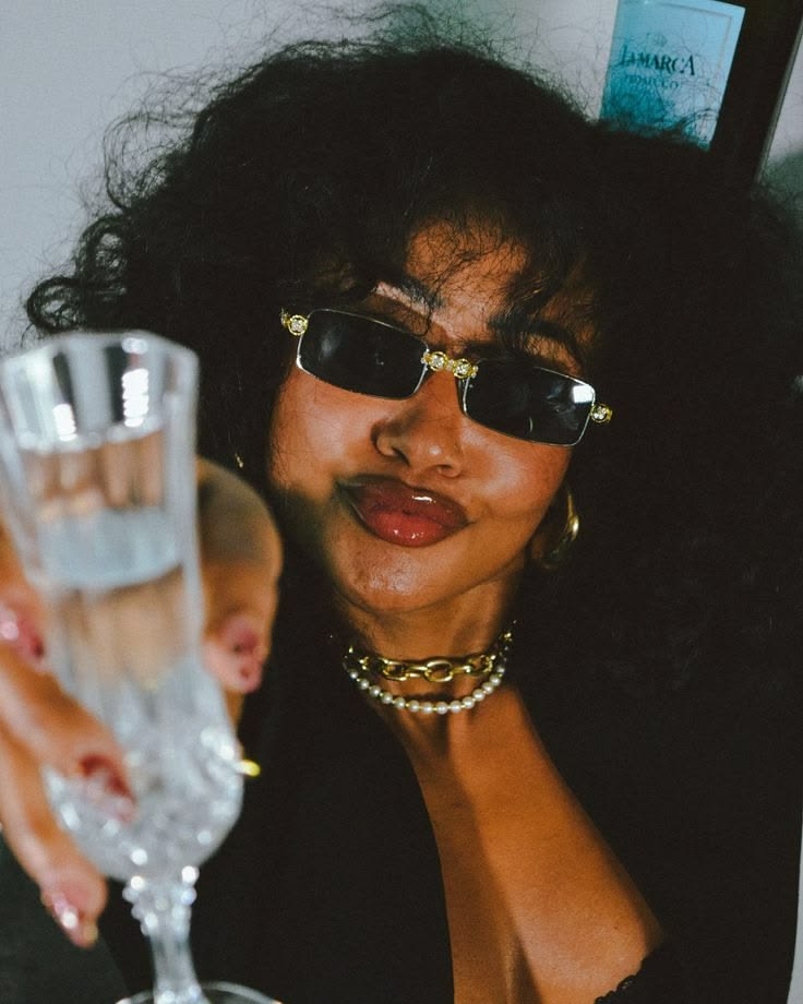 Woman in sunglasses enjoying a soft-life moment